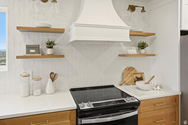 8760 Rustler Road Cottonwood Heights, UT 84093 - Photo 19 of 57 Kitchen featuring a white range hood, light wood-finish open shelving, and white countertops