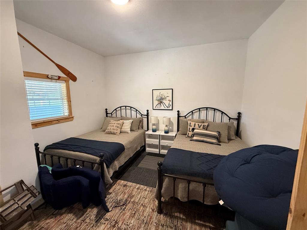 8072 Hells Gate Loop Strawn, TX 76475 - Photo 11 of 16 a bedroom with bed and a window