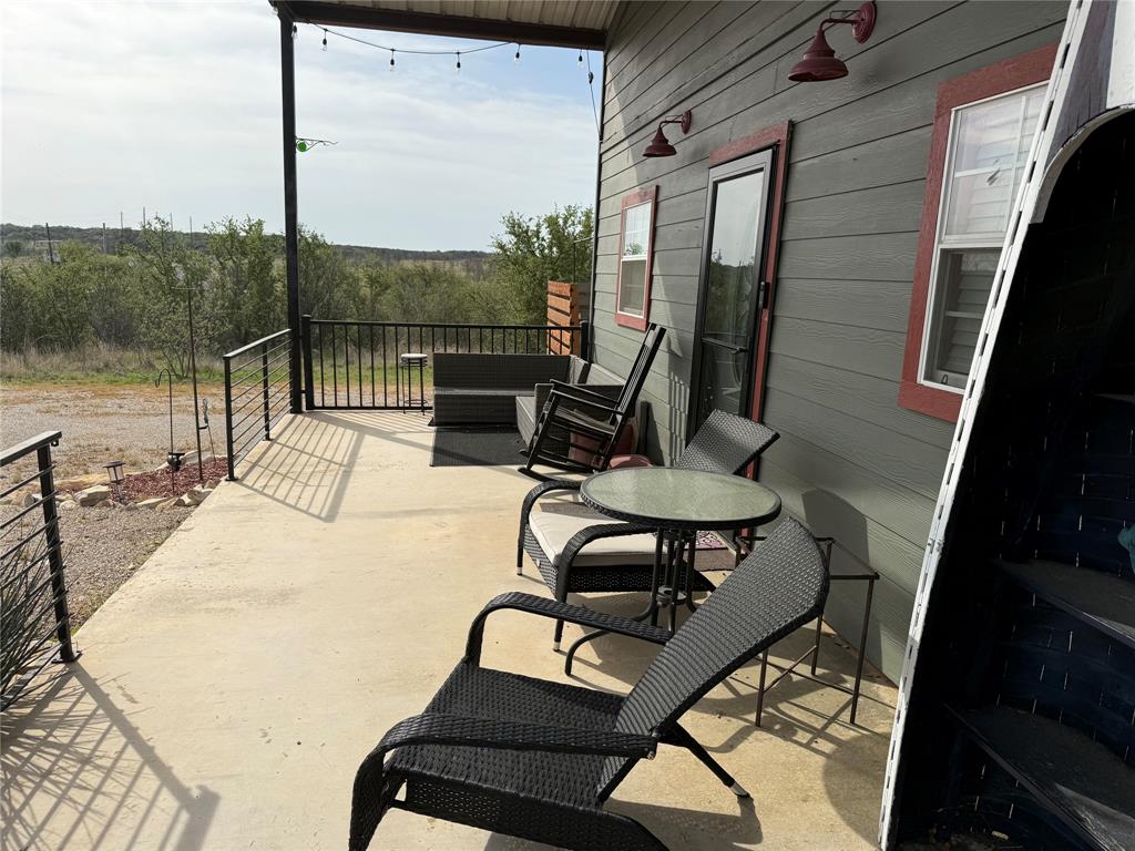8072 Hells Gate Loop Strawn, TX 76475 - Photo 15 of 16 a view of a chairs and table in patio