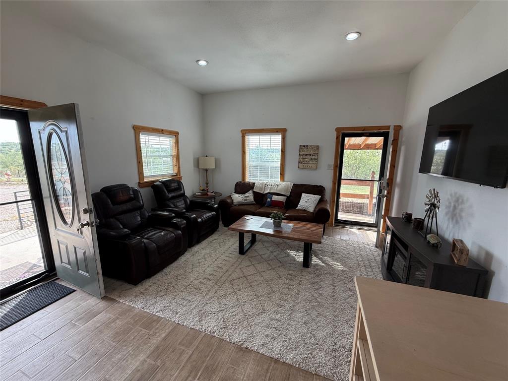 8072 Hells Gate Loop Strawn, TX 76475 - Photo 7 of 16 a living room with furniture and a flat screen tv