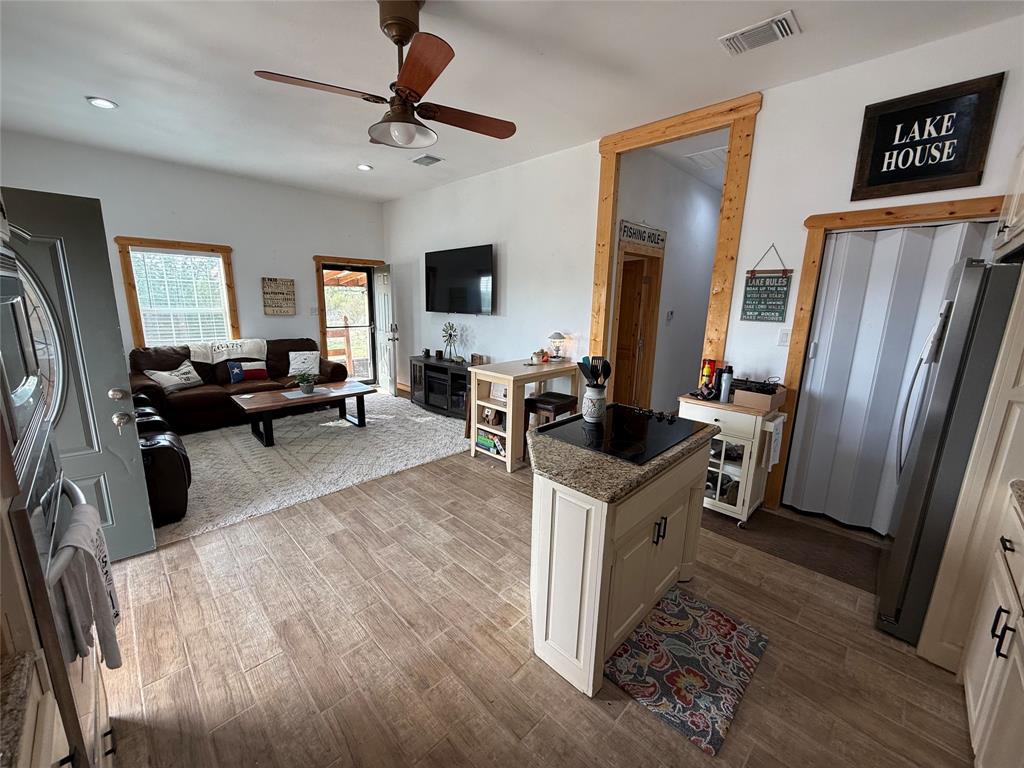 8072 Hells Gate Loop Strawn, TX 76475 - Photo 10 of 16 a living room with furniture a large window wooden floor and a rug