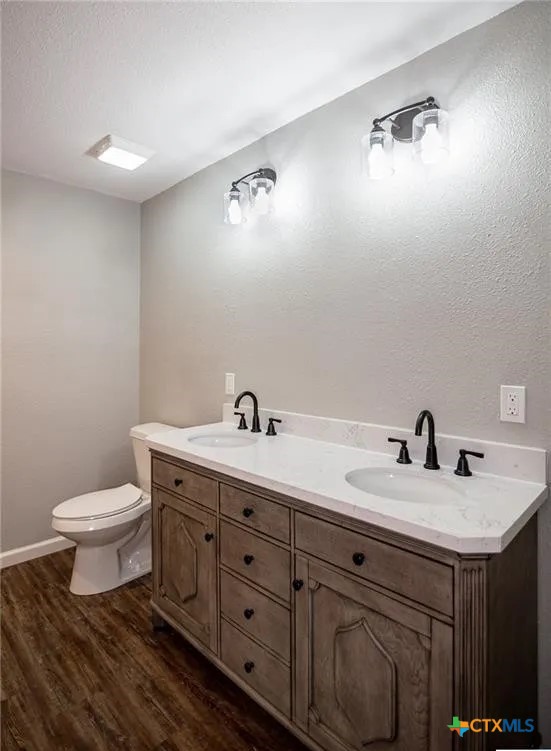 2003 Woodlawn Street Victoria, TX 77901 - Photo 30 of 35 a bathroom with a toilet sink and mirror