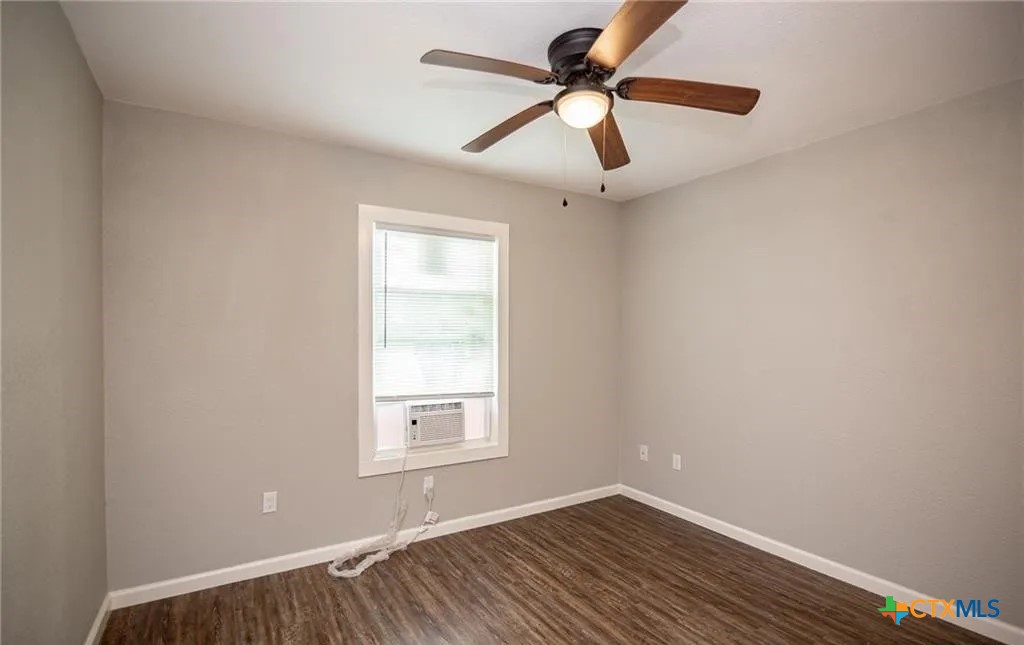 2003 Woodlawn Street Victoria, TX 77901 - Photo 32 of 35 an empty room with a window and a fan