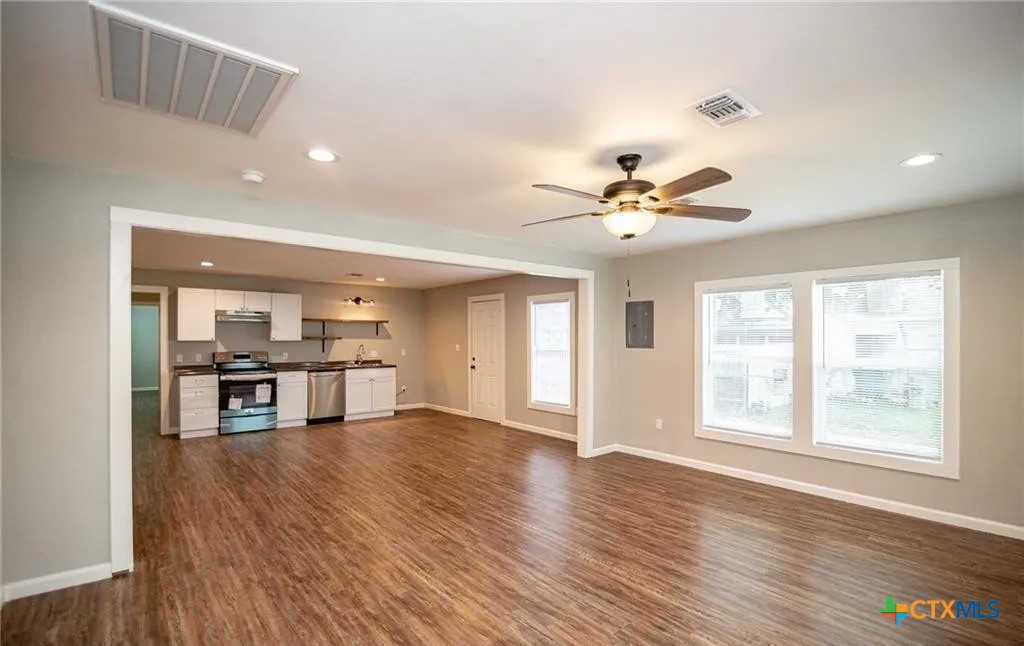 2003 Woodlawn Street Victoria, TX 77901 - Photo 4 of 35 a view of work and kitchen with a sink wooden floor and a window