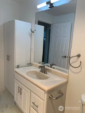 a bathroom with a sink and a mirror