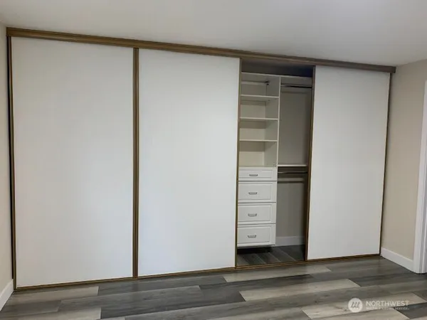 a view of walk in closet with empty racks