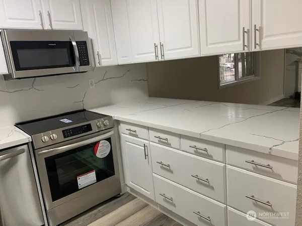 a stove top oven sitting inside of a kitchen