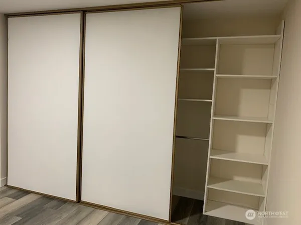 a view of walk in closet with empty racks
