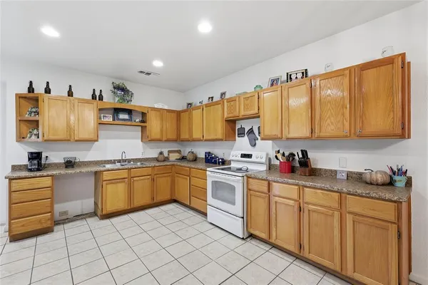 a kitchen with stainless steel appliances granite countertop a sink and cabinets