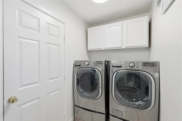 a utility room with sink dryer and washer