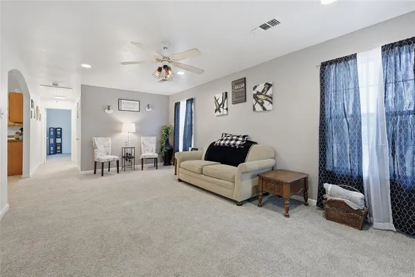 a living room with furniture and a chandelier