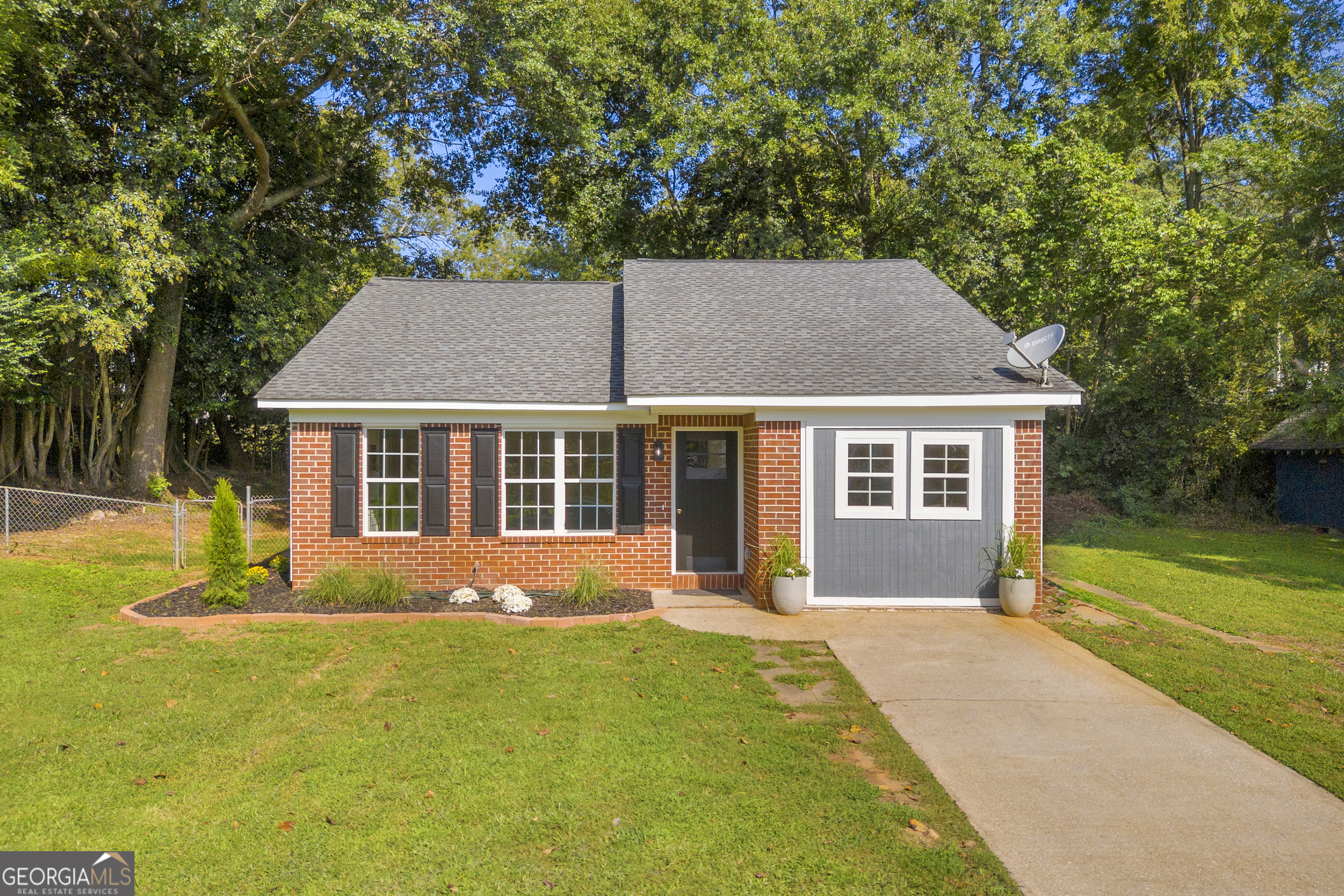 a front view of house with yard and green space