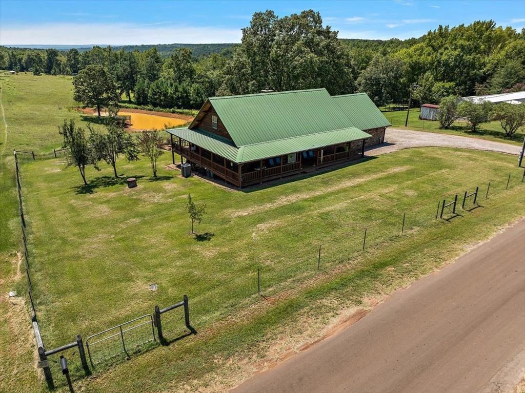 a view of a swimming pool with a patio and a yard