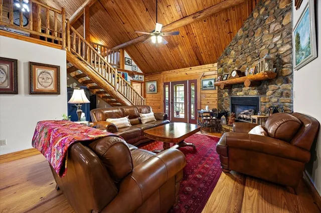 a living room with furniture fireplace and a table