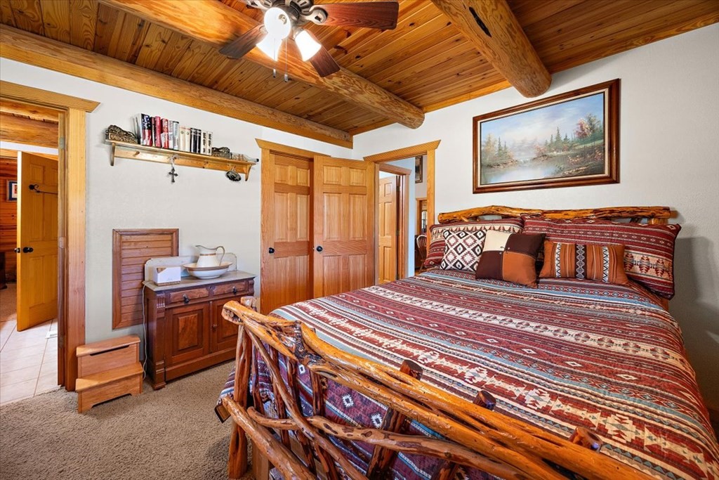 2000 County Road 852 Cushing, TX 75760 - Photo 21 of 50 a bedroom with a bed and wooden floor