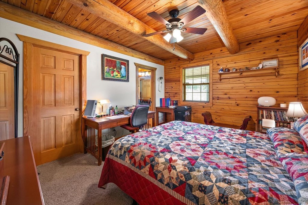 2000 County Road 852 Cushing, TX 75760 - Photo 24 of 50 a bedroom with a bed and wooden cabinets