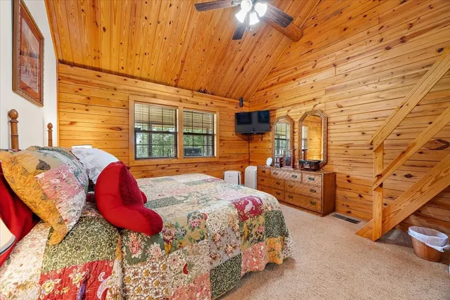 a spacious bedroom with a bed and a window