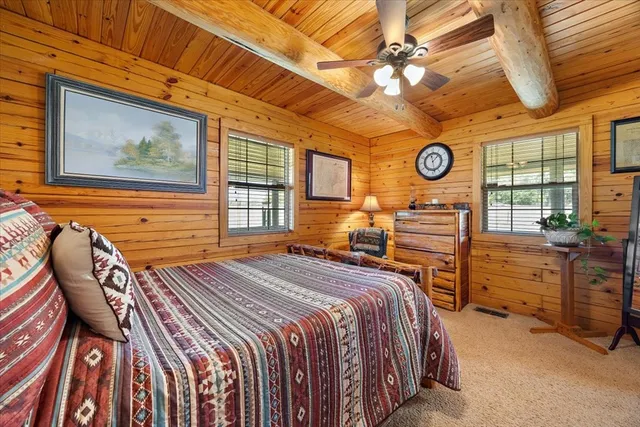 a bedroom with a bed and ceiling fan