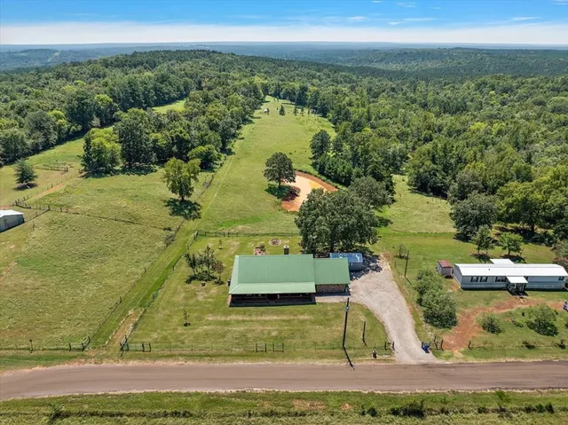 an aerial view of a houses with a yard