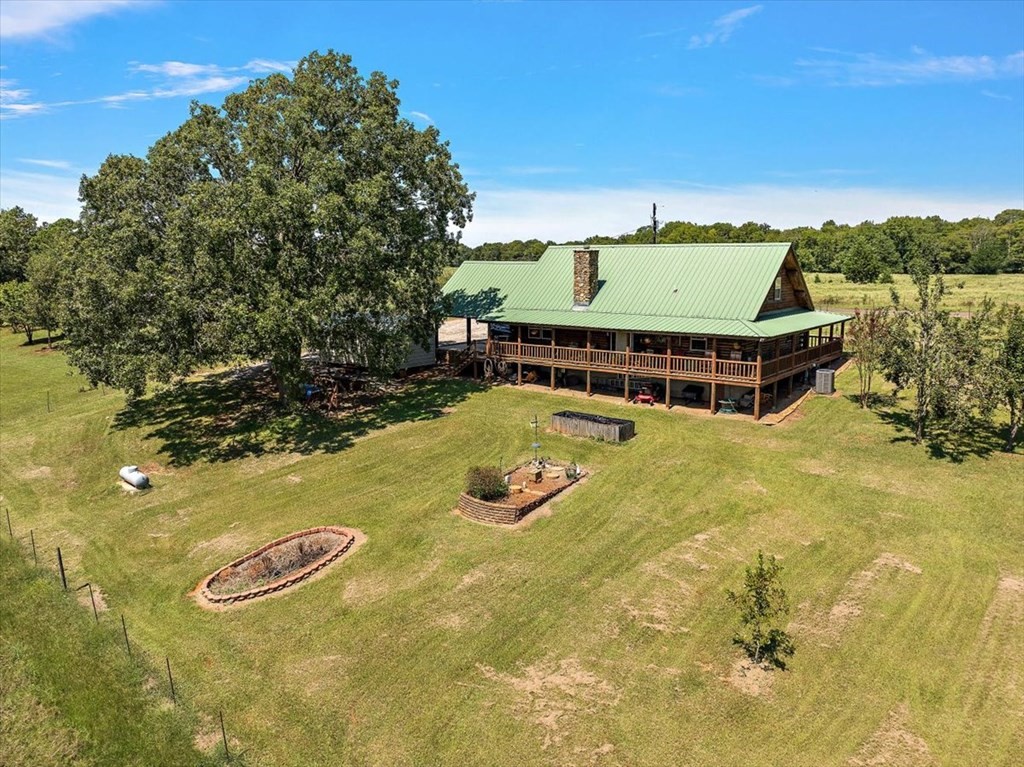 2000 County Road 852 Cushing, TX 75760 - Photo 6 of 50 a view of swimming pool with seating area and trees in the background