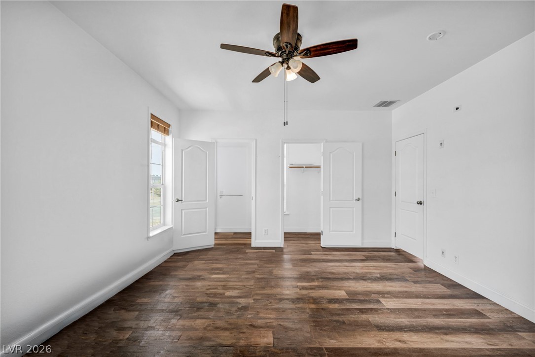 225 California Street Searchlight, NV 89046 - Photo 50 of 64 A well-lit bedroom features rich wood-look flooring and a functional ceiling fan.