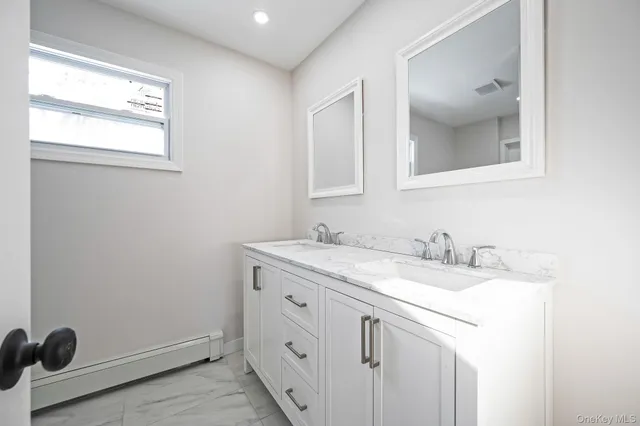 a bathroom with a granite countertop sink a toilet and bathtub