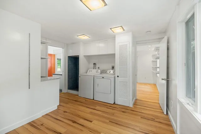 a kitchen with a refrigerator and white cabinets