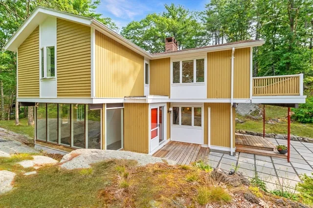 a view of a house with a backyard and balcony