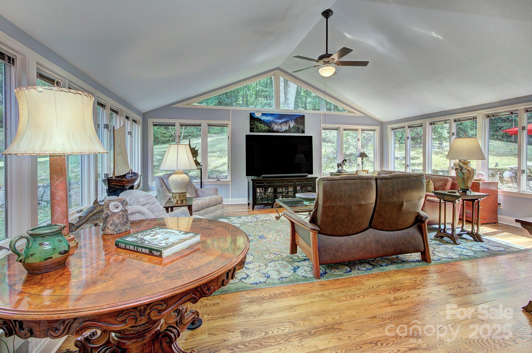 193 Duncan Creek Road Fletcher, NC 28732 - Photo 21 of 48 a living room with furniture a flat screen tv and a large window