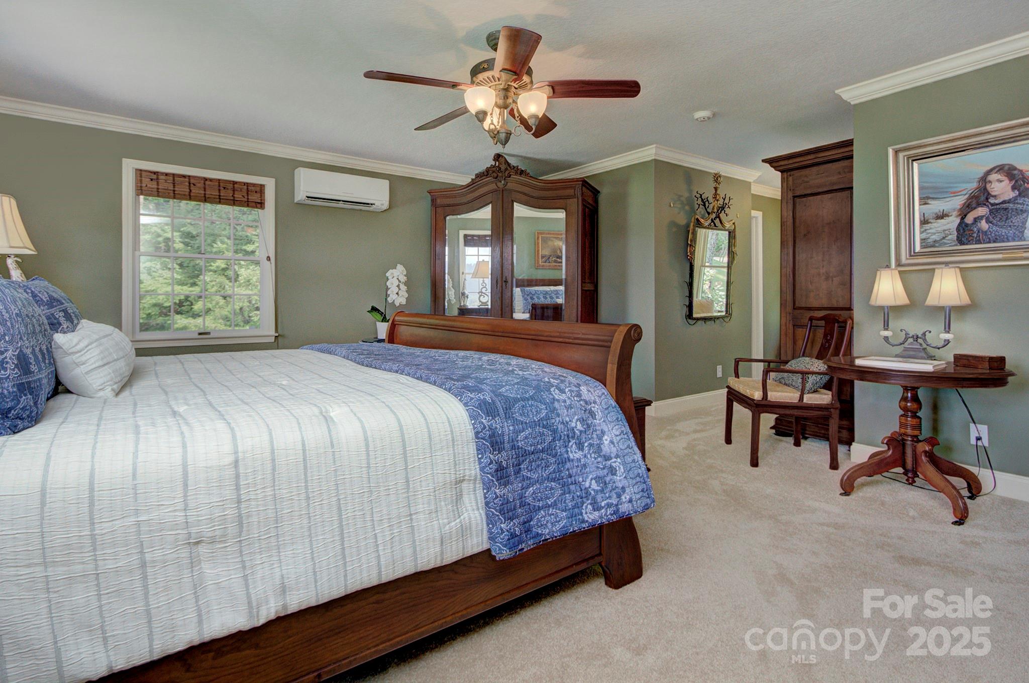 193 Duncan Creek Road Fletcher, NC 28732 - Photo 28 of 48 a bedroom with a bed and a chandelier