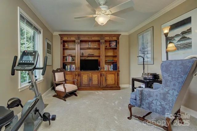 a living room with furniture and a floor to ceiling window