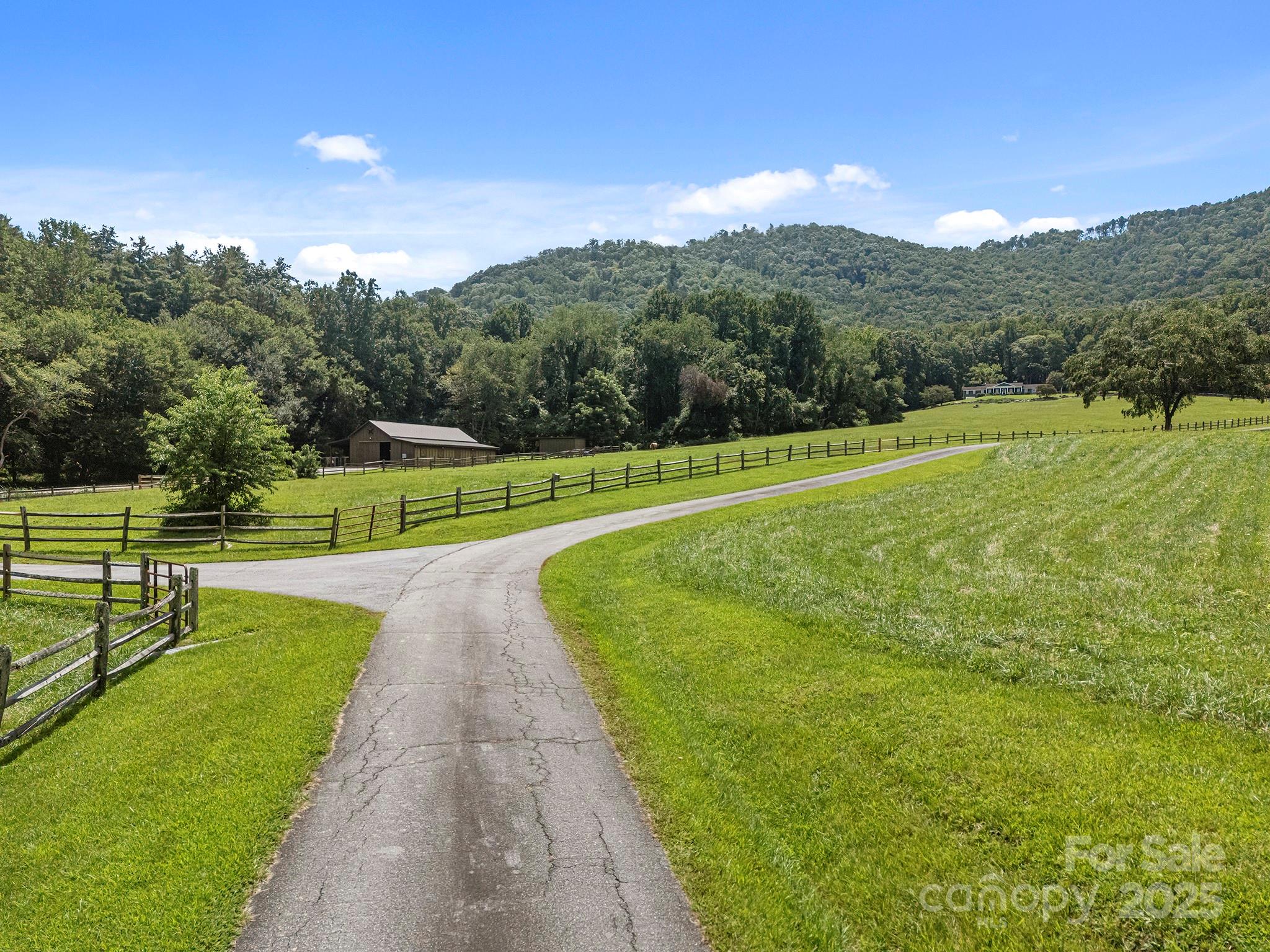 193 Duncan Creek Road Fletcher, NC 28732 - Photo 9 of 48 a view of a green field with clear sky