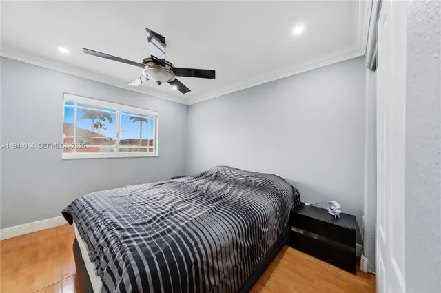 a bedroom with a bed and a painting on the wall