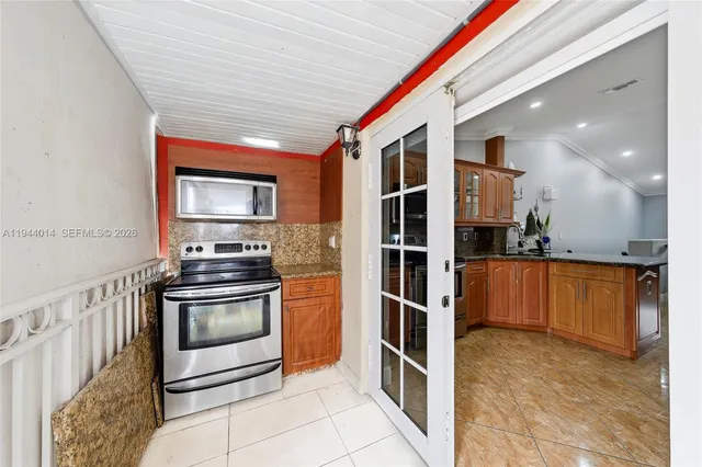 a kitchen with stainless steel appliances granite countertop a refrigerator and a stove