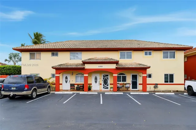 an outdoor space with furniture and palm trees
