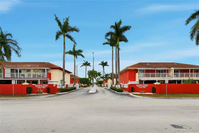 a swimming pool with outdoor seating and a potted plant
