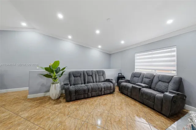a living room with furniture flowerpot and a window