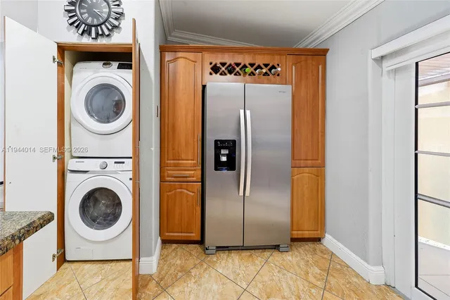 a view of a refrigerator in a utility room