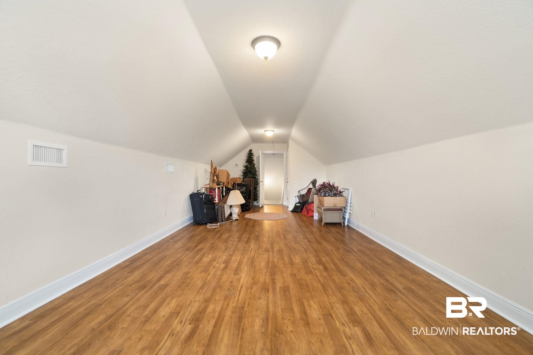 8664 Foxtail Loop Pensacola, FL 32526 - Photo 47 of 64 Bonus room featuring lofted ceiling, wood finished floors, and baseboards