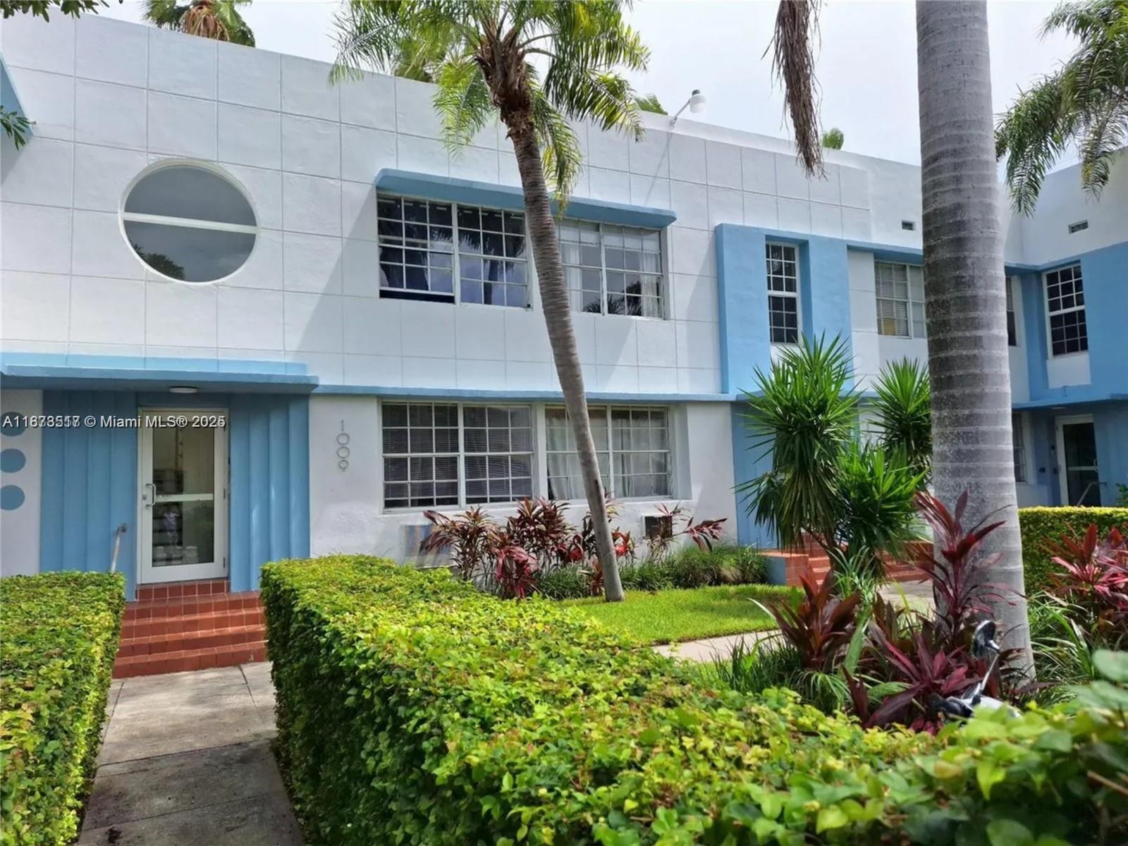 1009 Meridian Avenue, Unit 13 Miami Beach, FL 33139 - Photo 1 of 17 a front view of a house with a yard and garage