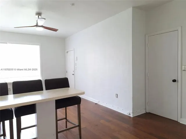 a living room with a couch and wooden floor