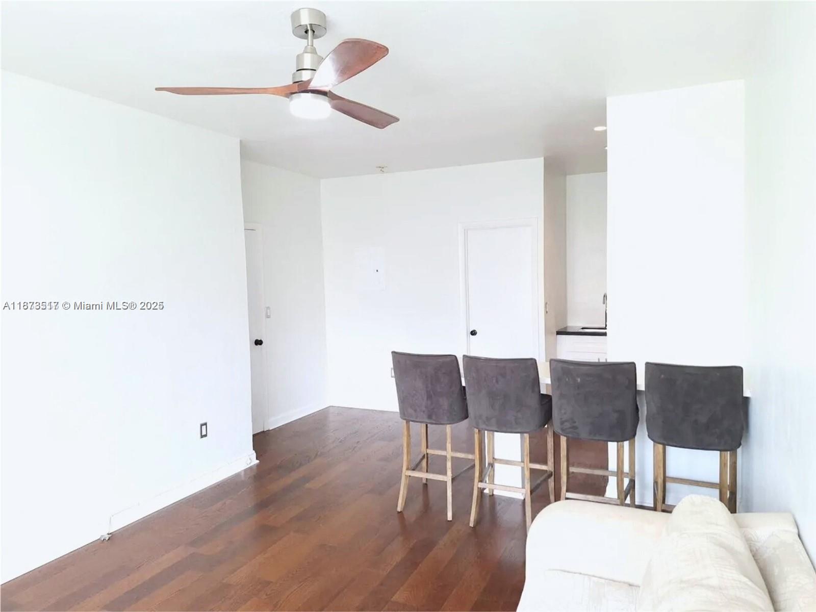 1009 Meridian Avenue, Unit 13 Miami Beach, FL 33139 - Photo 9 of 17 a view of a dining room with furniture and wooden floor