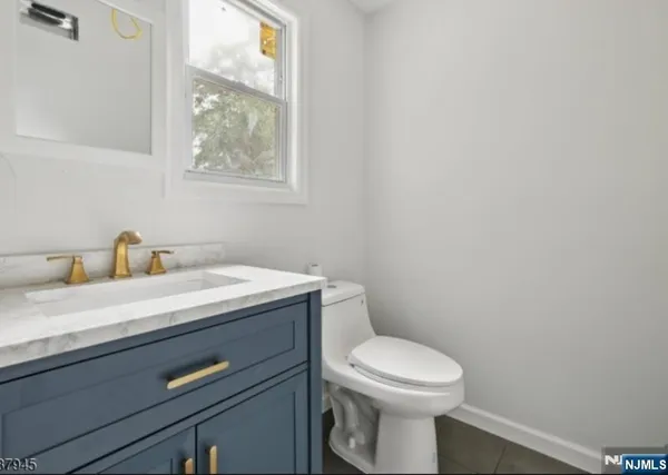 a bathroom with a toilet a sink and a window