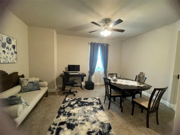 a view of a livingroom with furniture and a rug