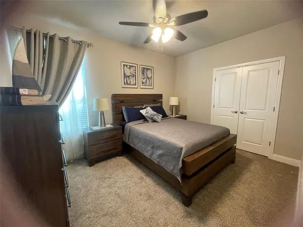a bedroom with a bed dresser and a window