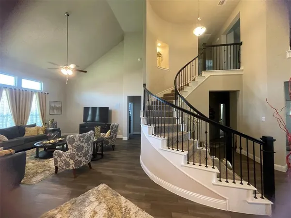 a living room with furniture or chandelier and a wooden floor