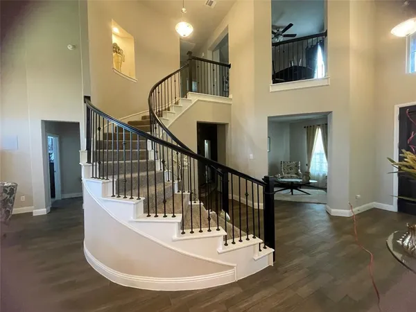 a view of entryway and hall with wooden floor