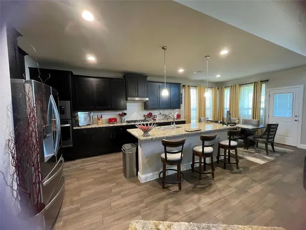 a open kitchen with a table and chairs