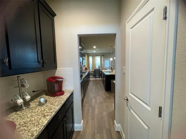 a kitchen with sink and refrigerator