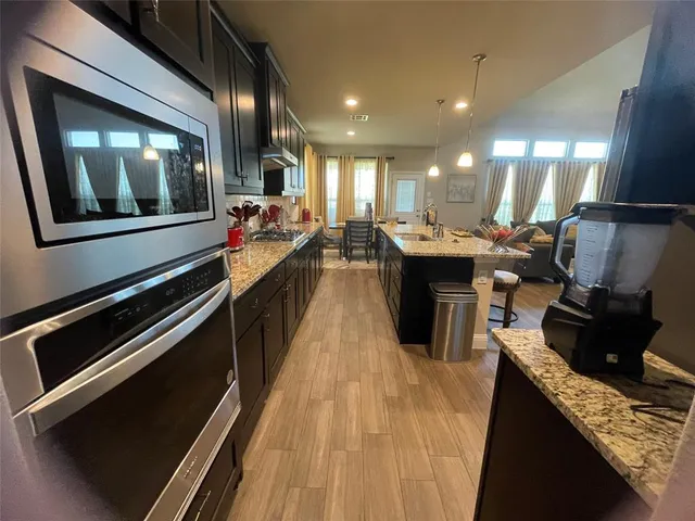 a kitchen with lots of counter top space and stainless steel appliances